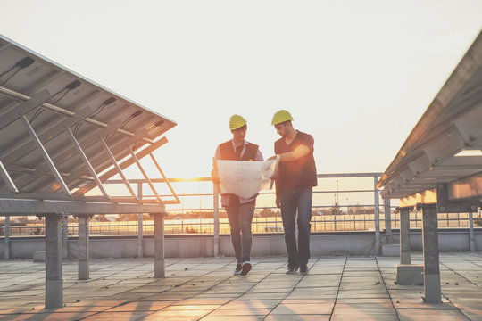 Architect and engineer inspecting solar power station