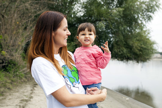 Portrait of mother and daughter on riverbank