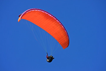 Paraglider in a blue sky