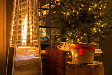 Street cafe with fireplace by night in Gdansk in winter time. Poland, Europe.