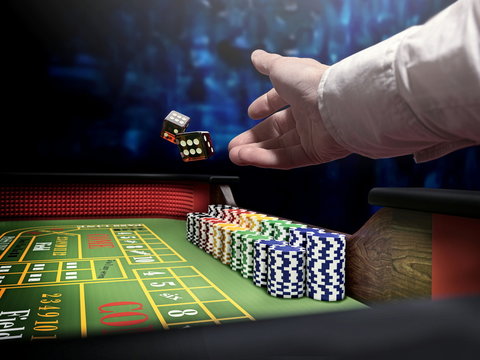 dice throw on craps table at casino