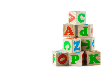 Wooden playing cubes with letters isolated on white background. Wooden blocks of the alphabet.
