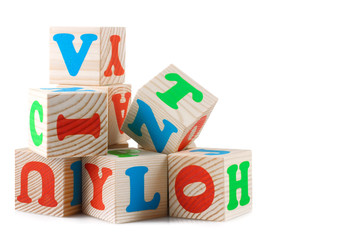 Wooden playing cubes with letters isolated on white background. Wooden blocks of the alphabet.
