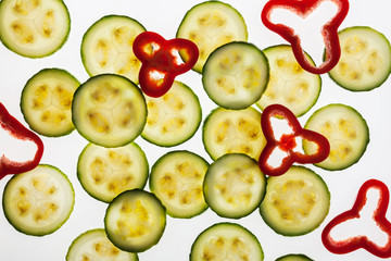 Backlit slices of zucchini and peppers, abstract textured background