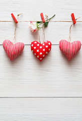 Fototapeta premium Valentine day background, pillow hearts border on wood