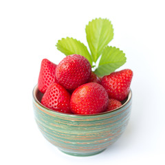 Fresh strawberries in a bowl on a white background