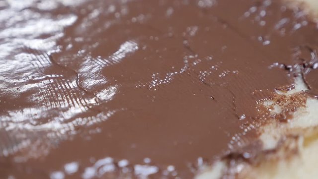 Hazelnut creme spreading over pancake texture slow-mo 1920X1080 HD tilting footage - Slow motion chocolate spread on tasty sweet dessert 1080p FullHD video 