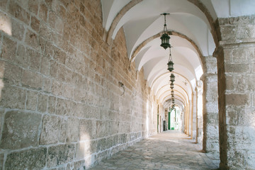 Old tunnel of arches and lanterns in an ancient town