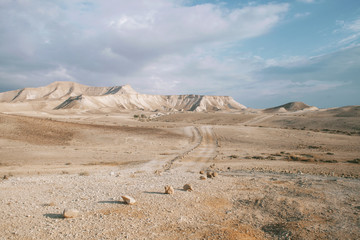 Trekking path in the mountains with a view of high rocks and blue sky