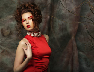young woman with creative visage wearing  red dress