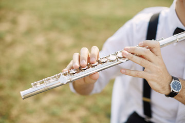 young man playing a clarinet or flute © eugenelucky