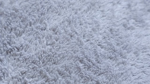 Gray synthetic fibers of polar blanket material close-up 4K 2160p 30fps UltraHD slow tilt footage - Warming polyester fleece fabric silver texture 3840X2160 UHD tilting video 