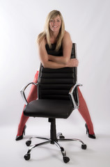 Sexy secretary leaning on an office chair