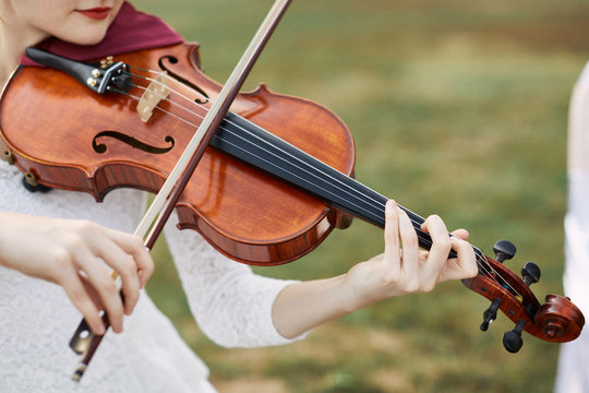 Violinist woman. Young woman playing a violin