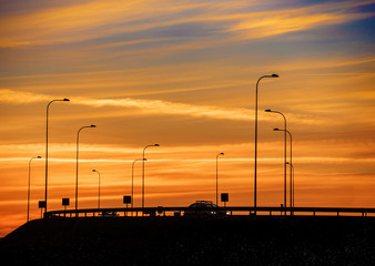 Fototapeta na wymiar Dramatic red sunset over highway