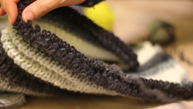 Knitting hands threads on spokes