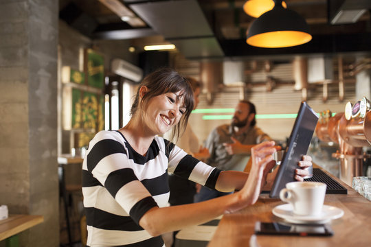 Woman in coffee shop using digital tablet