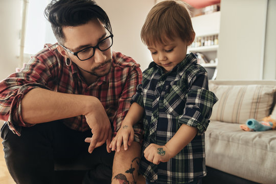 Proud son showing painted tattoo on his hand