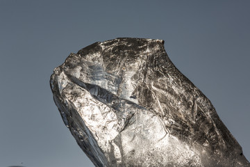 Fototapeta premium background ice, a large piece of ice on a blue background, water texture