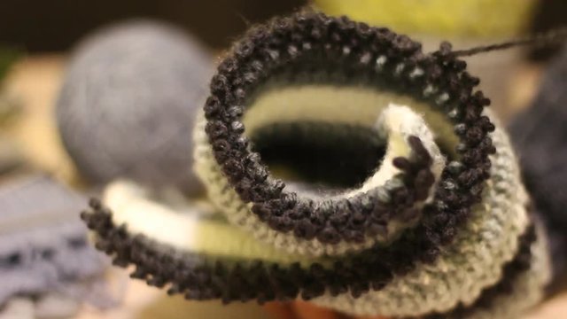 Knitting hands threads on spokes