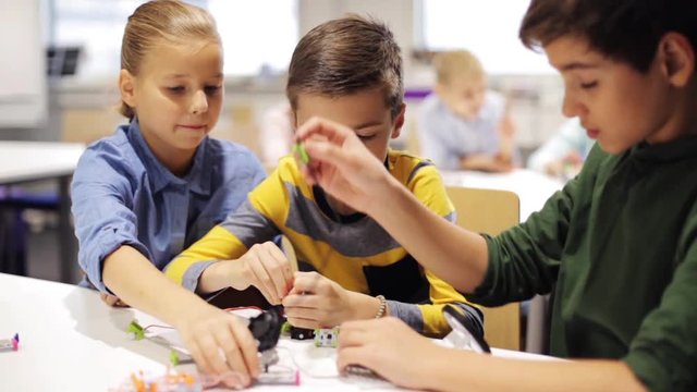 happy children making high five at robotics school
