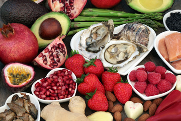 Aphrodisiac health food in heart shaped dishes and loose over marble background. Used to stimulate...