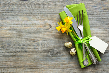 Easter table setting with daffodil and cutlery