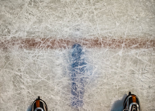 Figured hockey skates on ice background