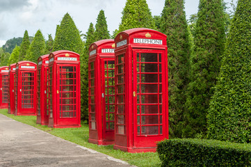 Red telephone booth. Thailand, Pattaya. A botanical garden of No