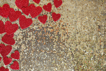 Red Sparkly Heart Confetti Framing Gold Sequin Background