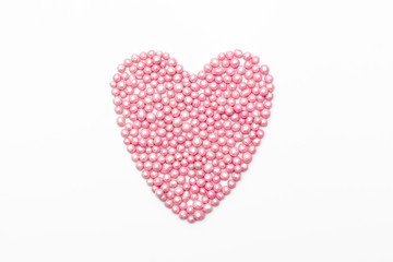 pink heart sprinkles on a white background. romantic love background for Valentine's day, birthday, holiday, party, wedding.