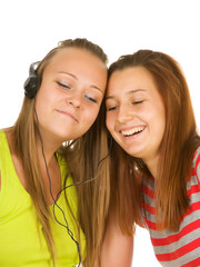 Two teenage girls listening to music on your mobile phone