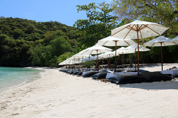 White umbrella and air cushion seat on the beach in Thailand. 