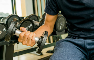 a man is exercise in the gym with dumbbell