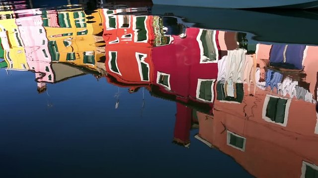 Reflection of a colorful houses in water canal, Burano island, Venice, Veneto region, Italy