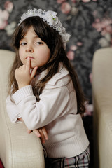 Small girl posing inside house during winter season