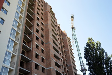 Construction of a skyscraper monolith and brick construction elements from a number of tower crane.