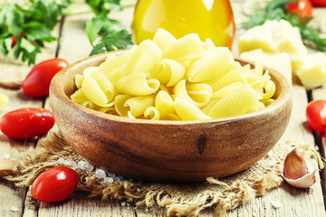 Ingredients for cooking pasta, old wooden table, rustic style, s