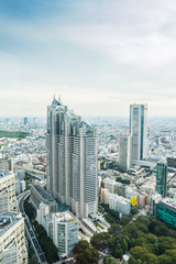 Fototapeta premium Business and culture concept - panoramic modern city skyline bird eye aerial view under dramatic sun and morning blue cloudy sky in Tokyo, Japan