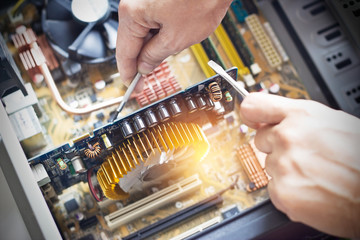  hands with tools to repair computer
