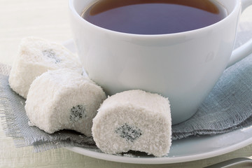  cup with tea and rahat-lokum in a coconut crumb