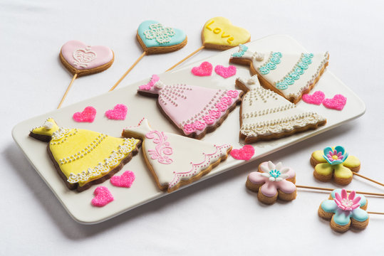 Cookies with glaze in the form of hearts, dresses and flowers.