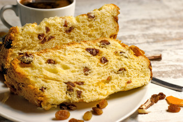 Fruit cake with raisins and coffee on rustic table