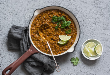 Cream coconut lentil curry in a cast iron skillet, top view. Healthy vegetarian food