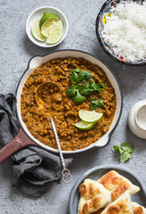 Cream coconut lentil curry, rice, naan bread - vegetarian lunch buffet. Top view, flat lay