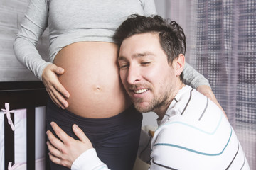 Pregnant Mother and her husband on baby room