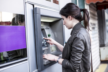 Fototapeta na wymiar Caucasian Woman at the ATM