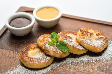 Fritters on a wooden stand.