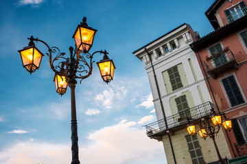 Fototapeta na wymiar Street lamp on sky background. Classic town buildings. Morning in Stresa.