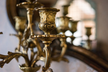 Part of gilded chandelier. Old chandelier indoors. Sell antiques at good price.